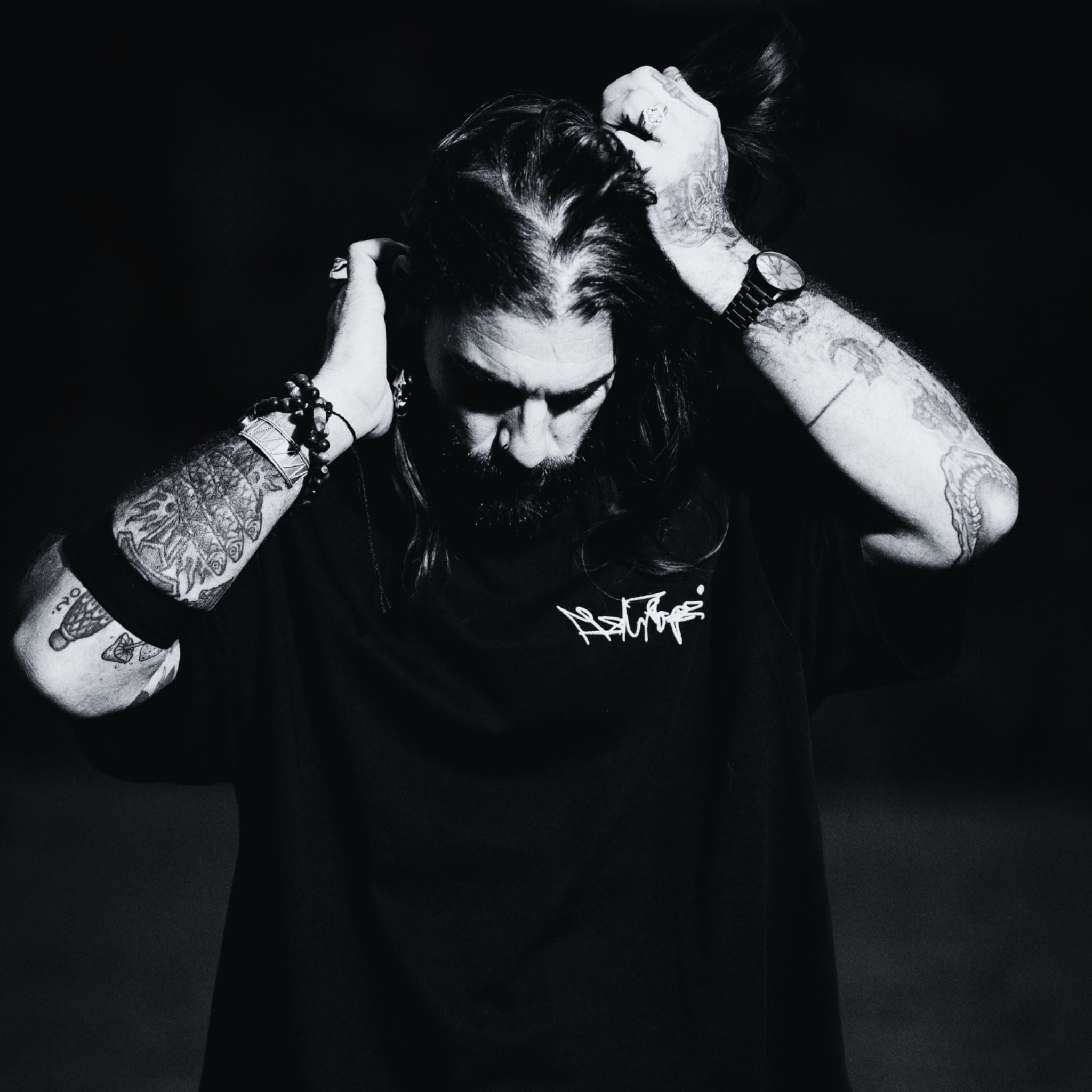 MSNTRPZ® MISANTHROPZ® Noir-Portrait eines langhaarigen tätowierten Models im schwarzen Premium Streetwear-Shirt | Premium German Streetwear